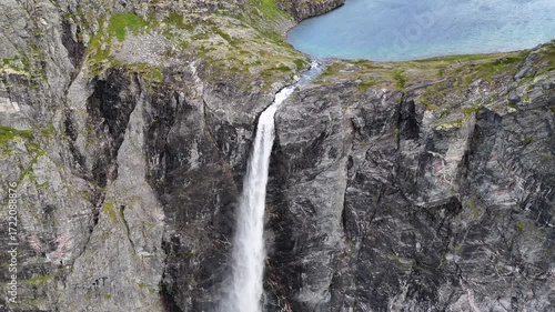 Epic waterfall in clouds zoom out drone shot, double waterfall of Mardalsfossen in Norway in 4K.