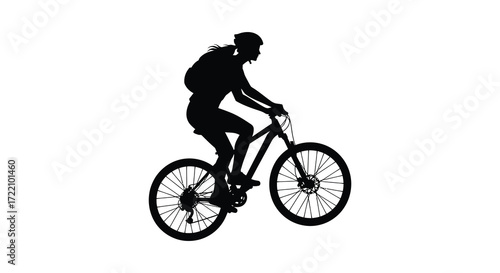 Silhouette of a mountain biker riding uphill in a dynamic pose