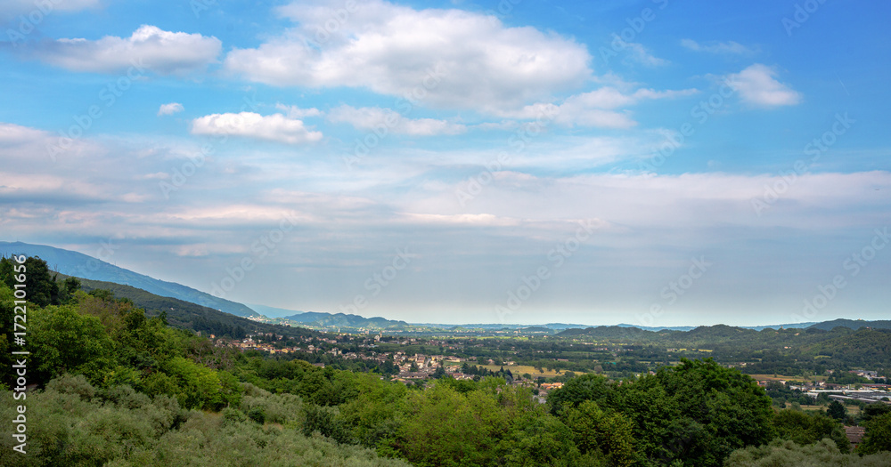 Obraz premium Scenic landscape in Possagno, Italy. view showcasing rolling hills, lush greenery, and a vibrant sky, highlighting the beauty of nature and tranquility in a serene environment with copy space