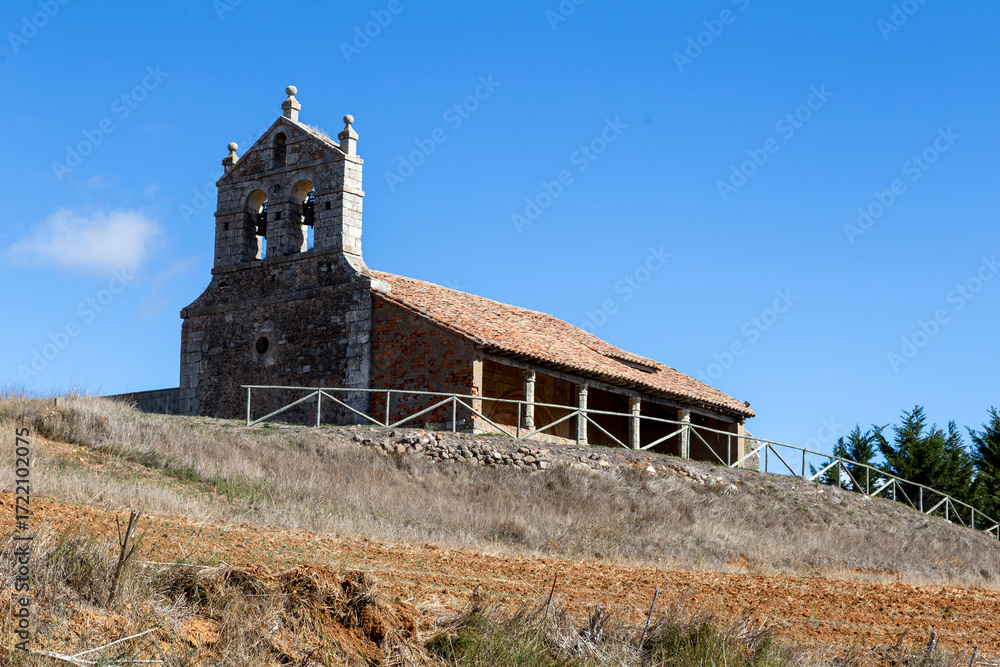 Fototapeta premium The Romanesque church of Saint Eugenia with its portico gallery on a hill in Dehesa de Romanos, Spain