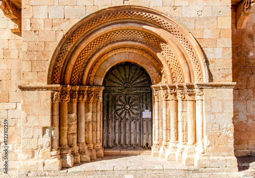 Romanesque portal with decorated archivolts at the Church of San Juan Bautista in Moarves de Ojeda, Palencia, Spain