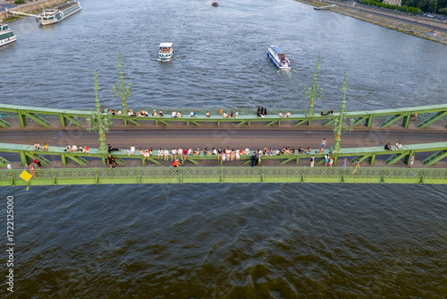People sitting on the Liberty bridge in Budapest city, Hungary, Europe.