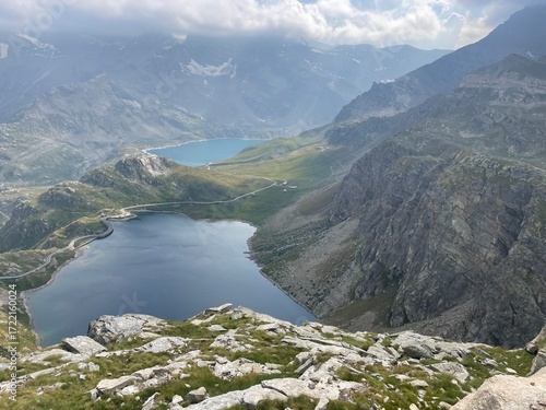 Panoramic view of the Nivolet Lakes, located in the Gran Paradiso National Park between Piedmont and Aosta Valley, Italy. The scene features two alpine lakes — Lago Serrù and Lago Agnel