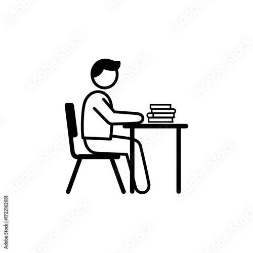 Student sitting at desk and studying with books in classroom  