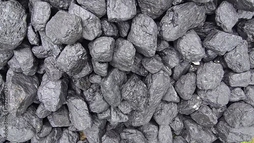 A pile of dark, lumpy coal gleams with a slight sheen, showing a rough, varied texture. Video 4k