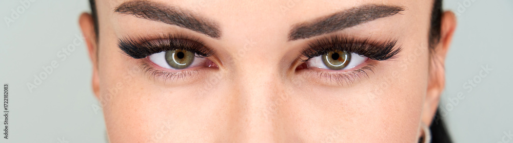 Obraz premium Cropped female face with long eyelashes closeup