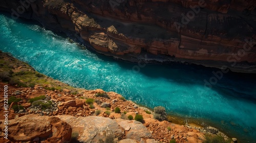 Turquoise River Flowing Through Red Rock Canyon with Rugged Cliffs