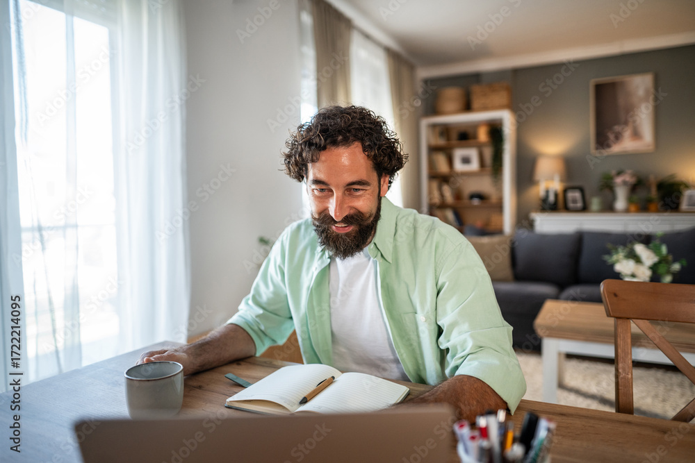 Obraz premium Man enjoying video call while working from home