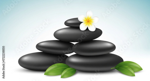 A stack of smooth black stones with a white flower on top and green leaves at the bottom on light background