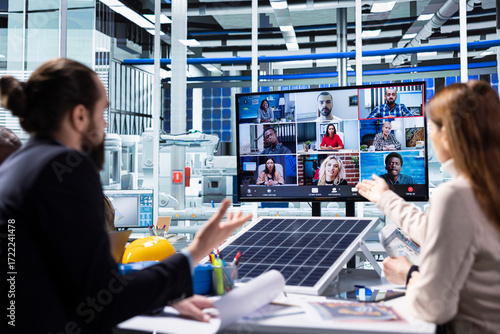 Papier peint Photovoltaics factory executive in remote videoconference meeting with shareholders showing data