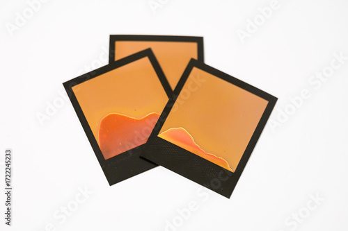 Failed Polaroid photo development — abstract patterns from improperly exposed instant film on white background
