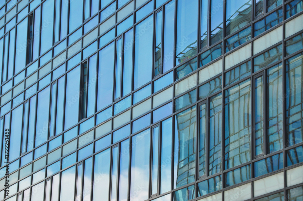 Obraz premium blue glass wall of office building mirror reflection