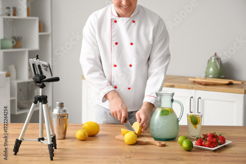 Male chef recording video o...