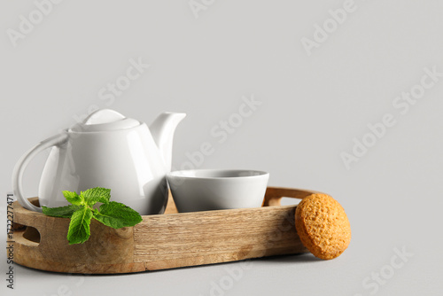 White ceramic teapot and cu...
