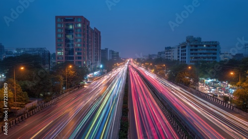 Vibrant Night Cityscape with Light Trails from Traffic on Busy Urban Highway at Dusk