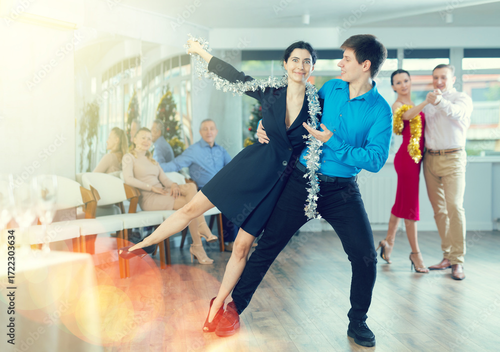 Fototapeta premium Young couple rehearsing and dancing in dance class