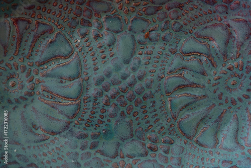 Symmetrical patterns embedded into clay pottery dish
