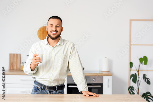 Young man with glass of mil...