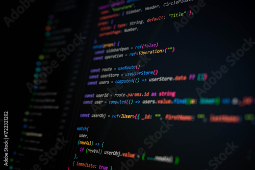 Behang Close-up of TypeScript code on dark screen showing reactive functions with refs, route, and user object, symbolizing modern web development, clean coding practices, and software engineering