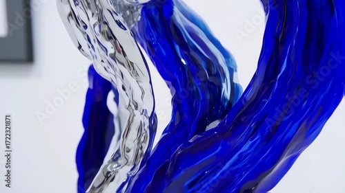 Abstract sculpture, flowing forms of silver and deep blue