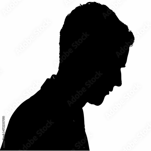 Silhouette of a young man looking down thoughtfully