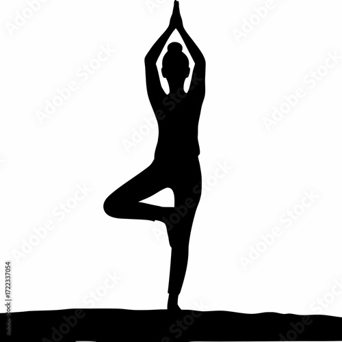 Silhouette of a woman performing the tree pose in yoga