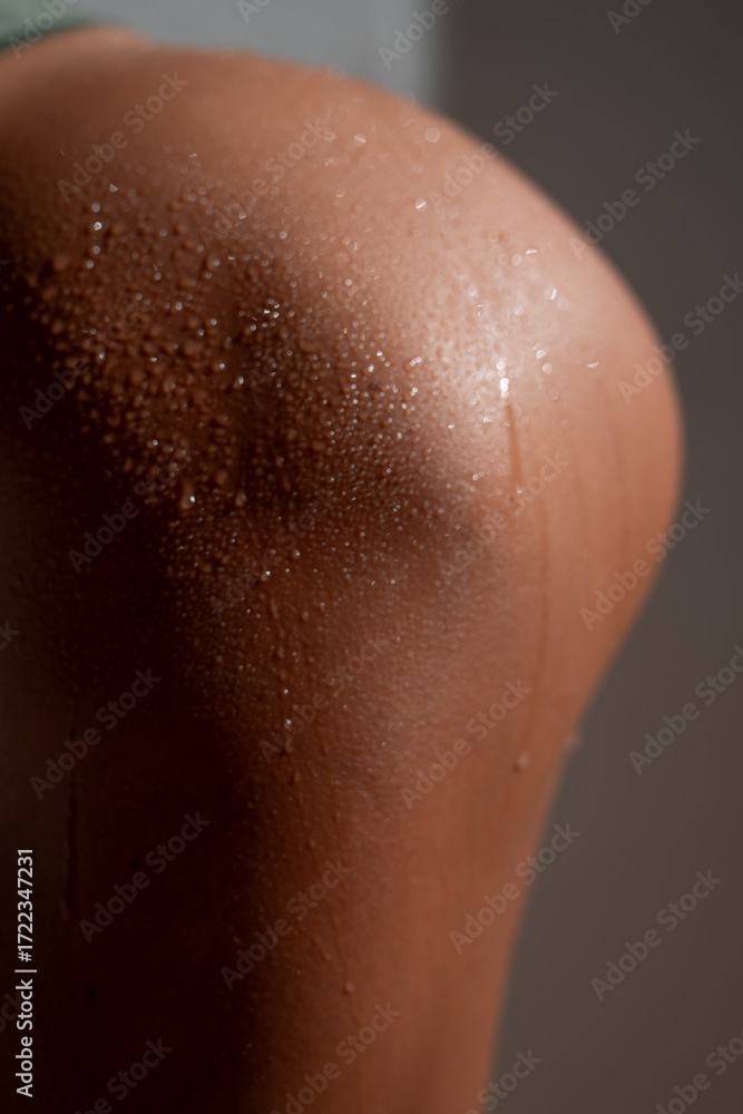 Fototapeta premium Macro close up of athletic female body with wet skin and sweat drops, highlighting natural texture, sensual detail and fitness lifestyle concept