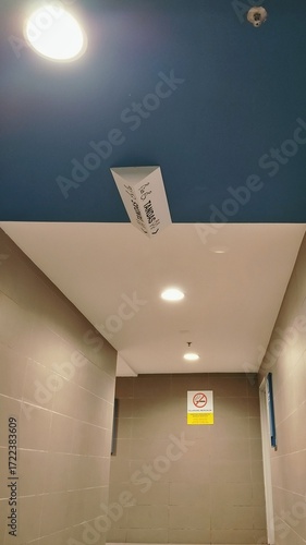 A hallway with signage indicating the direction to the restrooms, along with a 