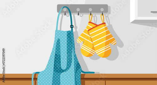 A Polka-Dot Apron and Oven Mitts Hanging on a Wall