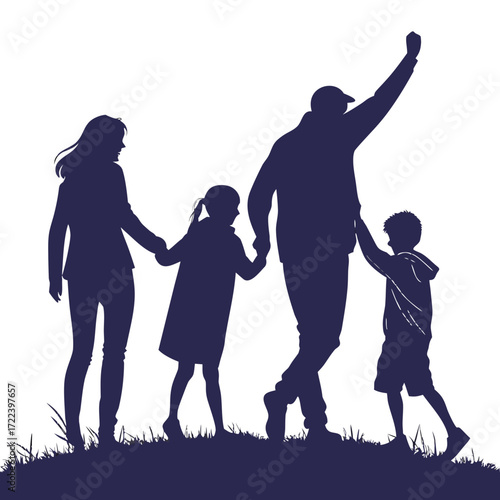 A happy family silhouette of parents and two children walking together holding hands on a grassy hill