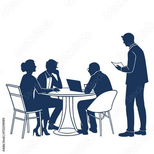 Diverse business professionals collaborating around a table with a laptop and one standing presenting ideas
