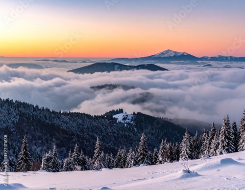 Winter landscape view of mountains covered in trees & snow below a sea of clouds illuminated by a colorful sunrise/sunset