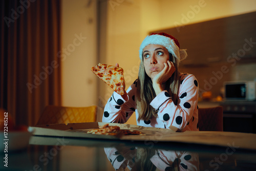 Sad Lonely Woman Eating Pizza at Home During Christmas Time. Unhappy depressed girl having fast food on winter holidays 
