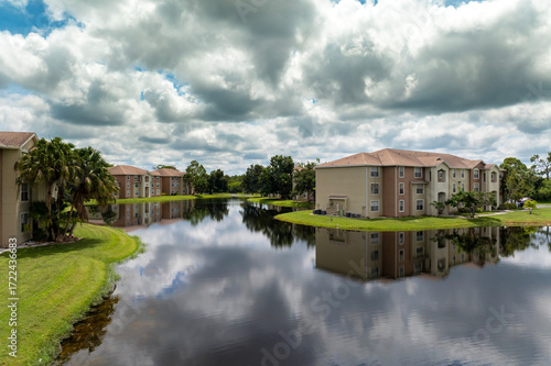 Family houses with retention ponds to prevent flooding in Florida closed suburban area. Real estate development in American suburbs