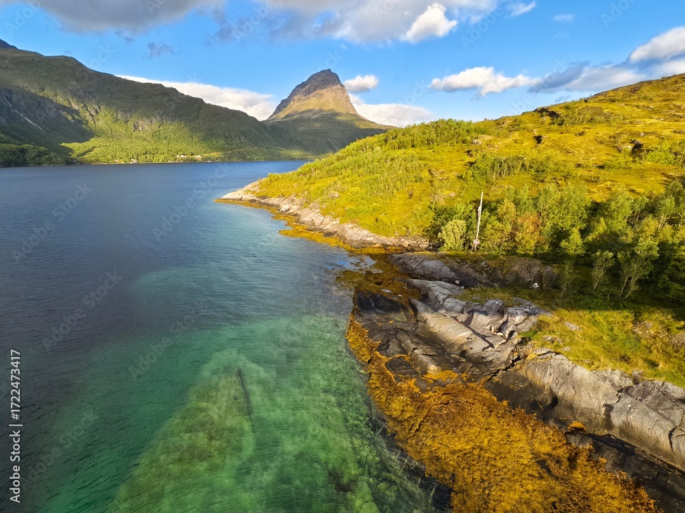 Fototapeta premium Beautiful sea bay with crystal clear water and mountains in the background in Norway