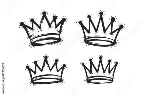 Four stylized crowns with grunge spray paint accents. Vector hand drawn illustration