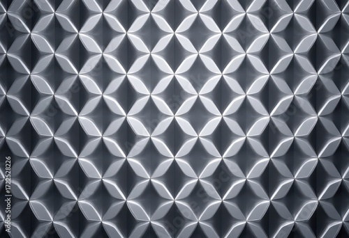 A geometric, repeating pattern of raised, leaf-like shapes creates a three-dimensional effect on a smooth, gray surface.