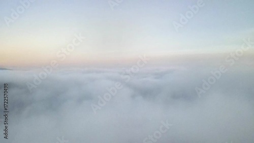 Aerial View of a Serene Mountain Forest Emerging from a Sea of Clouds at Dawn