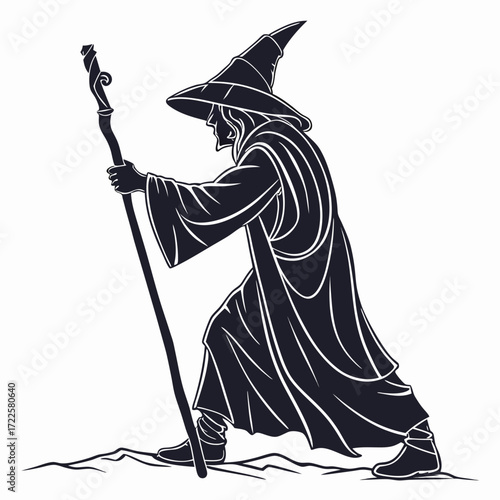 Mysterious wizard with pointed hat and staff walking across a barren landscape silhouette
