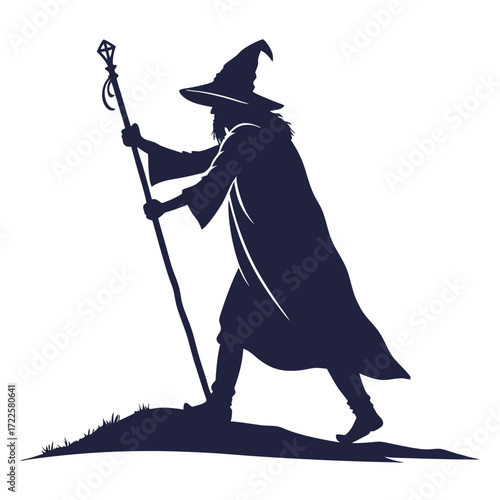 Mysterious wizard silhouette with pointed hat and staff walking on grassy hill