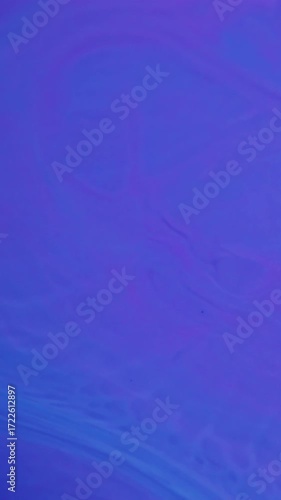 Wallpaper Mural Vertical video. Liquid texture. Wave ink. Defocused blue neon color chemical paint in water spreading on enamel marble abstract background. Torontodigital.ca