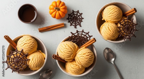 Halloween pumpkin spice ice cream in bowls with spiderweb decoration