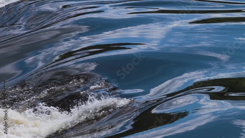 Close up view of the fast flowing tannic waters of the Gatineau river rapids.