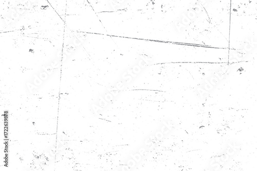 A close-up, high-angle shot of a white surface with numerous fine scratches and smudges.