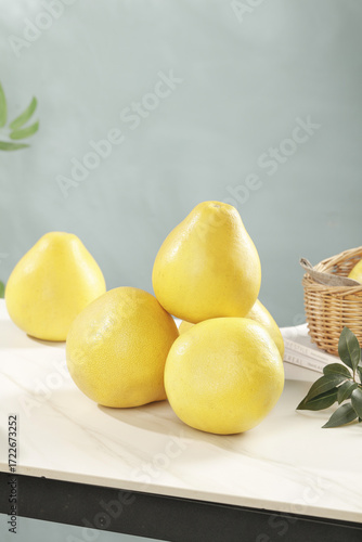 Fresh Yellow Pomelo Citrus Fruits on Marble Surface with Natural Kitchen Styling