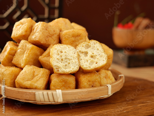 Golden Fried Tofu Puffs in Bamboo Basket - Traditional Asian Cooking Ingredient