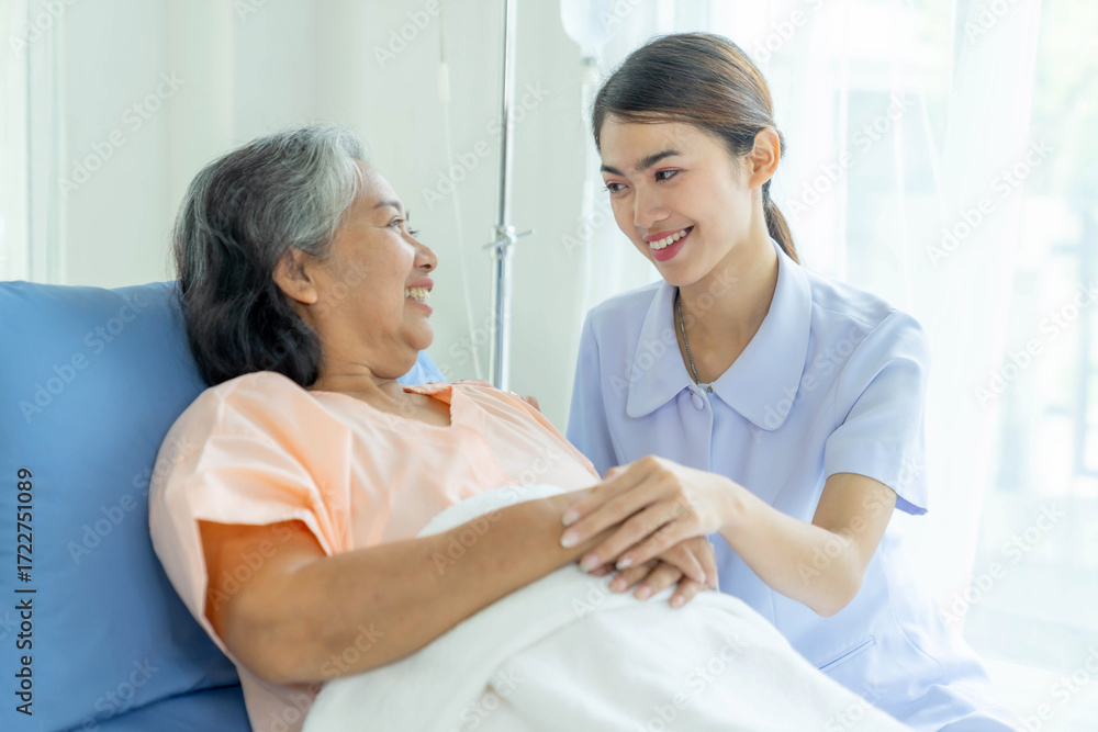 Obraz premium Smiling nurse taking care of elderly patient in hospital bed, healthcare support and medical service with compassion, professional caregiver providing assistance and encouragement to senior woman