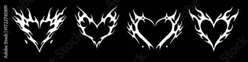 Vector illustration features four stylized white tribal flame heart designs on a black background. The edgy tattoo-inspired style combines love and fire motifs using bold, dynamic shapes and contrast.