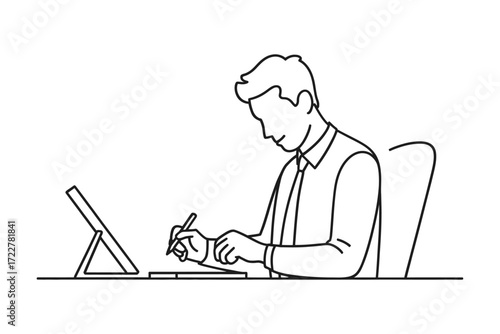 Man working on laptop and taking notes at desk