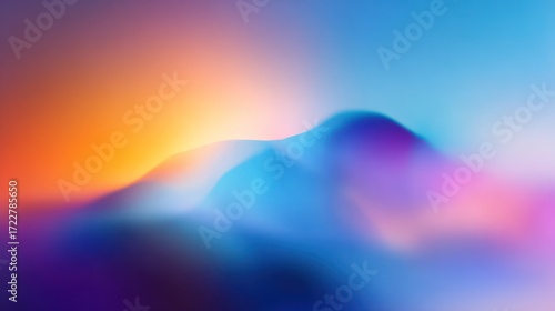 Blurred, vibrant gradient of orange, blue, purple creating an abstract mountain range